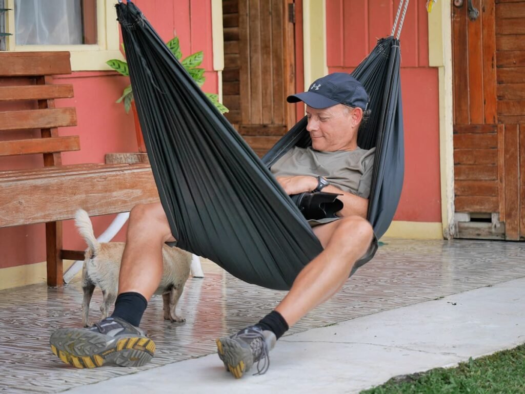 A guest unwinds in a hammock at Tuete Farm Tours, embodying the 'Pura Vida' lifestyle during our authentic full-day farm experience in La Fortuna, Costa Rica.