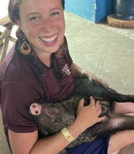 Authentic Costa Rican farm, a delighted tourist during a hands-on farm experience, showing genuine connection and the Pura Vida lifestyle at Tuete Farm.